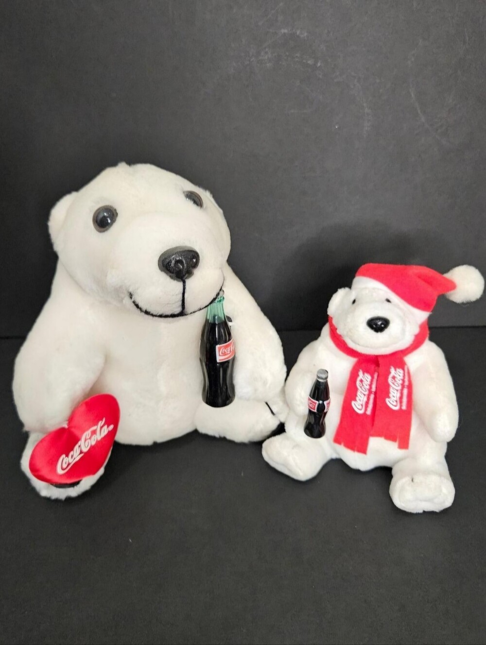 Two soft white Vintage Coca-Cola Plush Polar Bears holding miniature Coca-cola